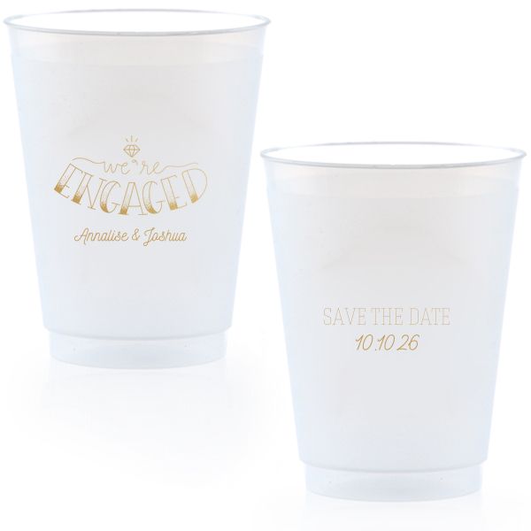 The Diamond Engagement Cup design dazzles with a sparkling diamond graphic and bold "ENGAGED" in 3D artistry. Scripted "we’re" and the couple's names add charm, while the other side cheerfully announces "Save the Date," infusing the cup with celebratory excitement and anticipation.