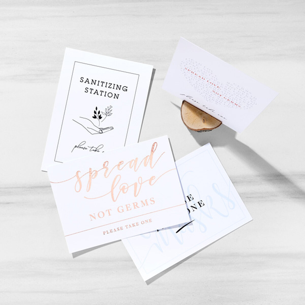 A collection of social distancing and station tabletop signs foil stamped with black or shiny gold foil
