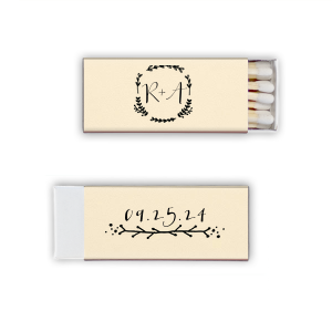 The Branch Wedding Wreath Matchbox exudes a charming, homespun vibe. Its front showcases a heart-leaf wreath encircling the couple’s initials, symbolizing their united love. On the back, a whimsical branch underlines a handwritten-style date, embodying natural beauty and simplicity.