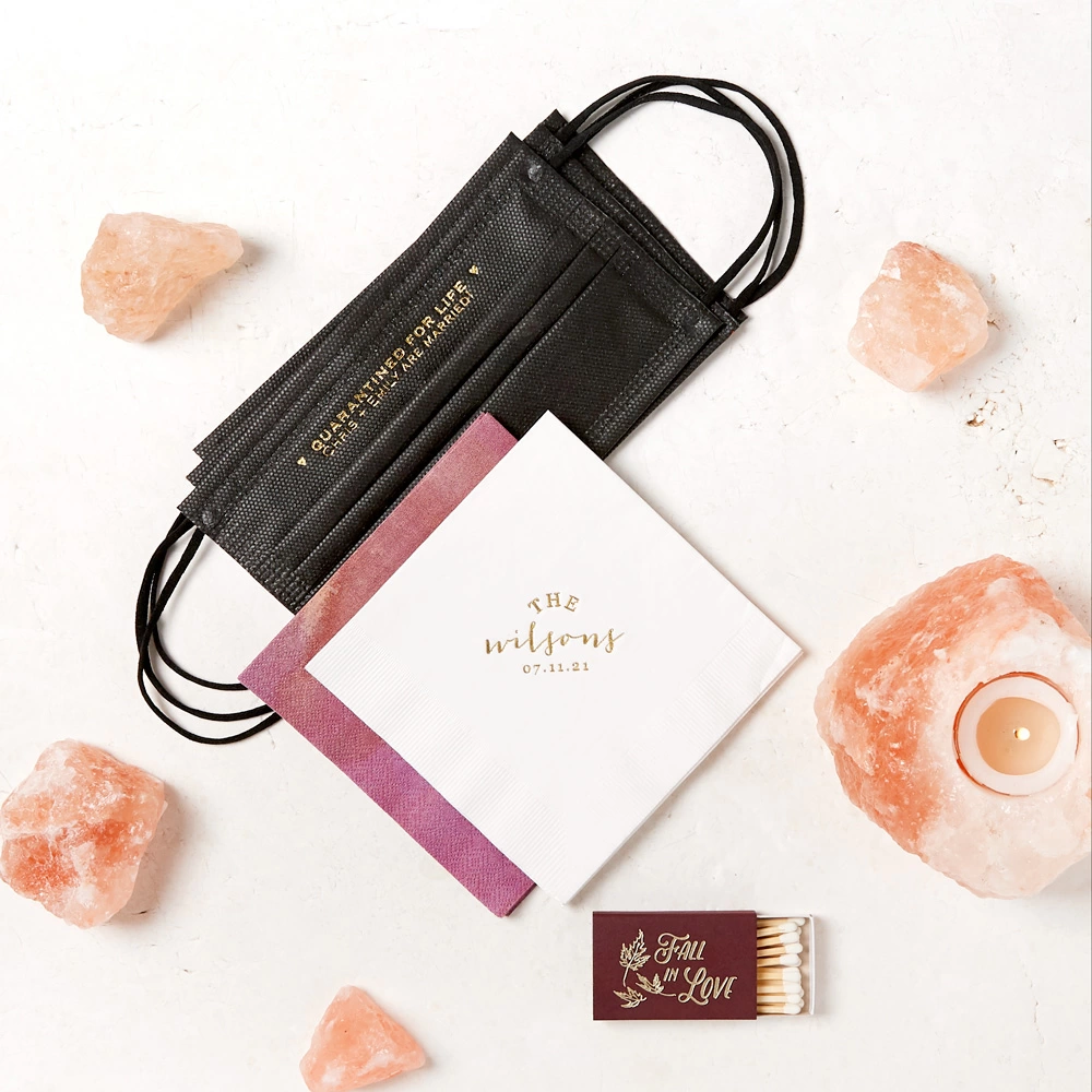 Custom designed cocktail napkins, disposable face masks and hand sanitizers are a 2021 wedding essential.