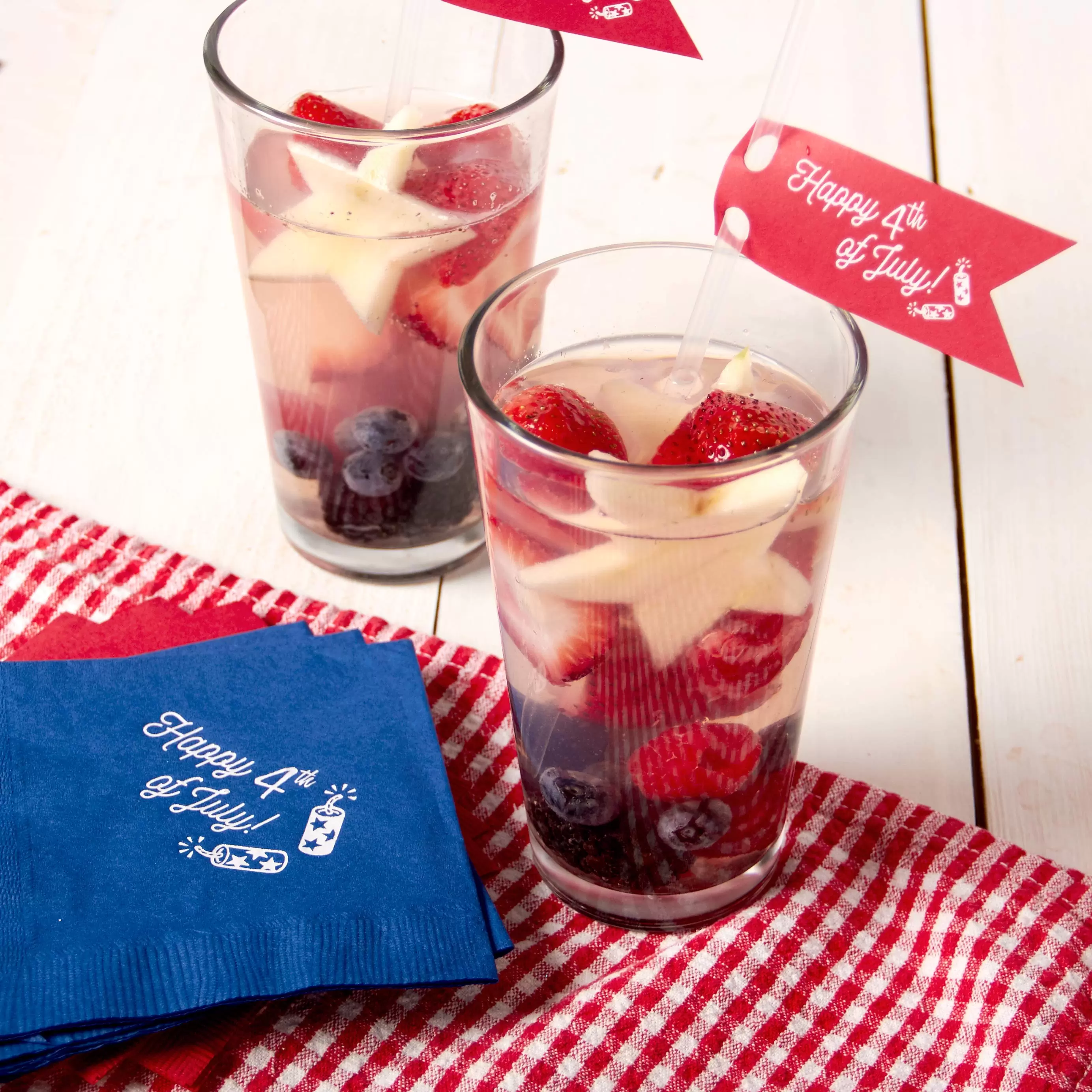 4th of july cocktail with personalized napkins and custom straw tags
