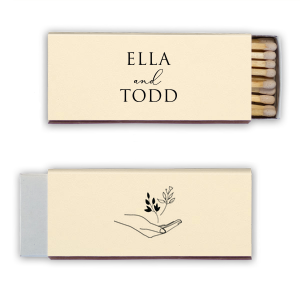 Light up your meaningful moments with the Handheld Floral Names Match. It features bespoke names on the front, while the back displays an open hand cradling tender shoots, symbolizing care and growth. This matchbox is a poetic nod to nurturing new beginnings together. Ideal for weddings and milestone celebrations.