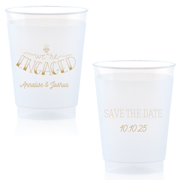 The Diamond Engagement Cup design dazzles with a sparkling diamond graphic and bold "ENGAGED" in 3D artistry. Scripted "we’re" and the couple's names add charm, while the other side cheerfully announces "Save the Date," infusing the cup with celebratory excitement and anticipation.