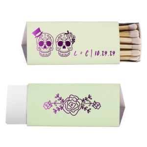 Celebrate love and life with the Sugar Skull Couple Match. Featuring vibrantly detailed skulls adorned with a top hat and floral headband, this artistic design nods to the joyous spirit of Día de los Muertos. Displaying the couple's initials and event date, it's a colorful keepsake full of cultural charm and festivity.