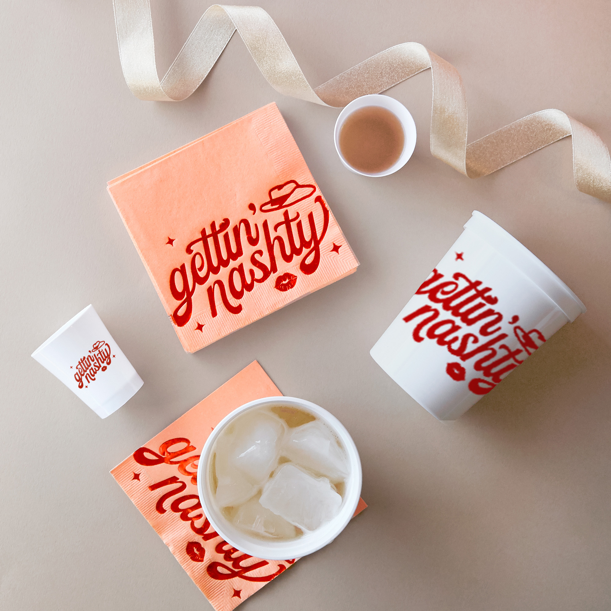 Party scene with white cups and shot glasses