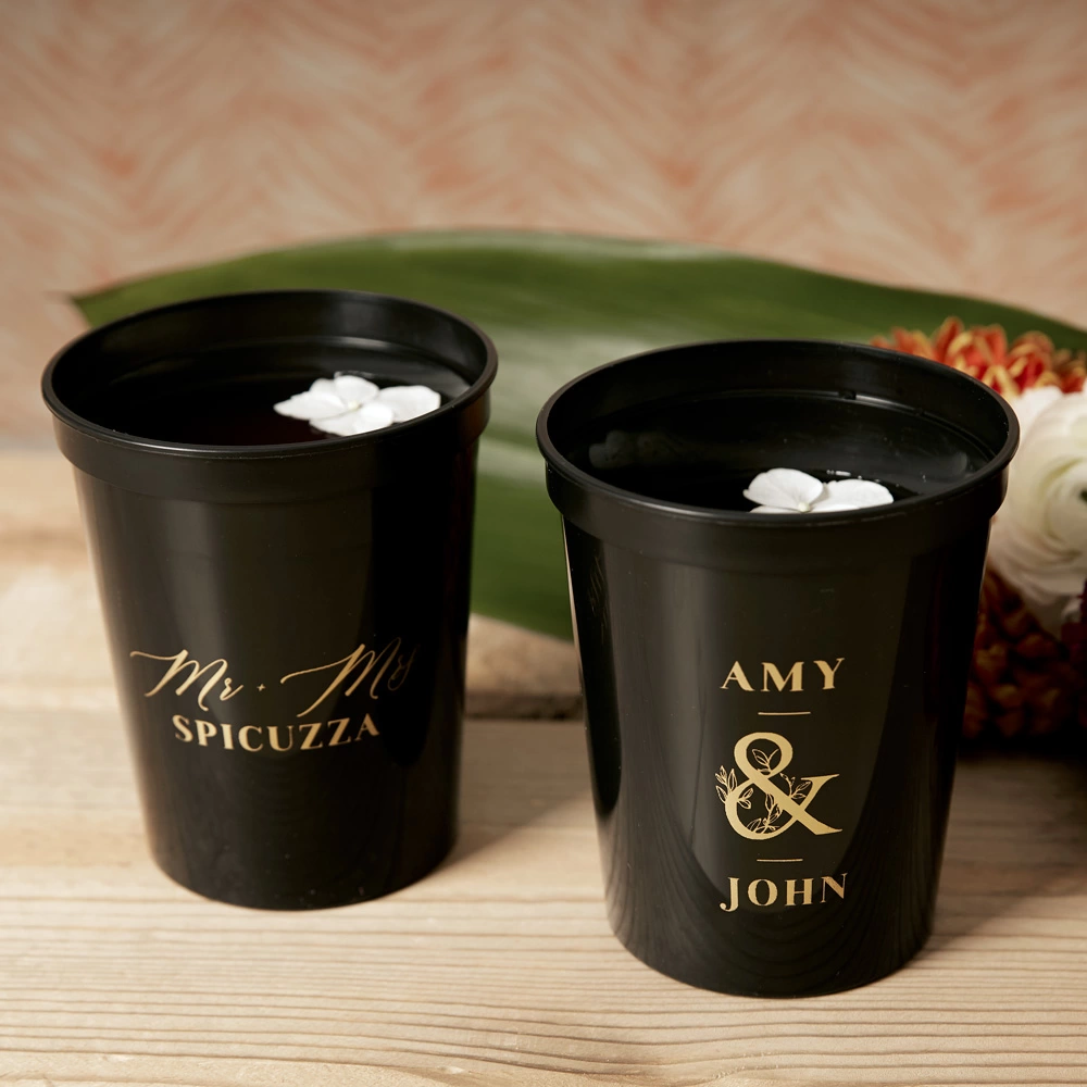 Custom stadium cups in dramatic black with gold printing will add a personalized touch to your Wild Winter wedding.