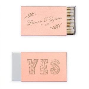 Ignite love’s spark with the Romantic YES Wedding Matchbox. Elegant leafy boughs frame the newlyweds' names in flourishing script on one side. Flip to an exuberant, floral-filled "YES" on the other—a timeless, botanical cheer for your happily ever after!