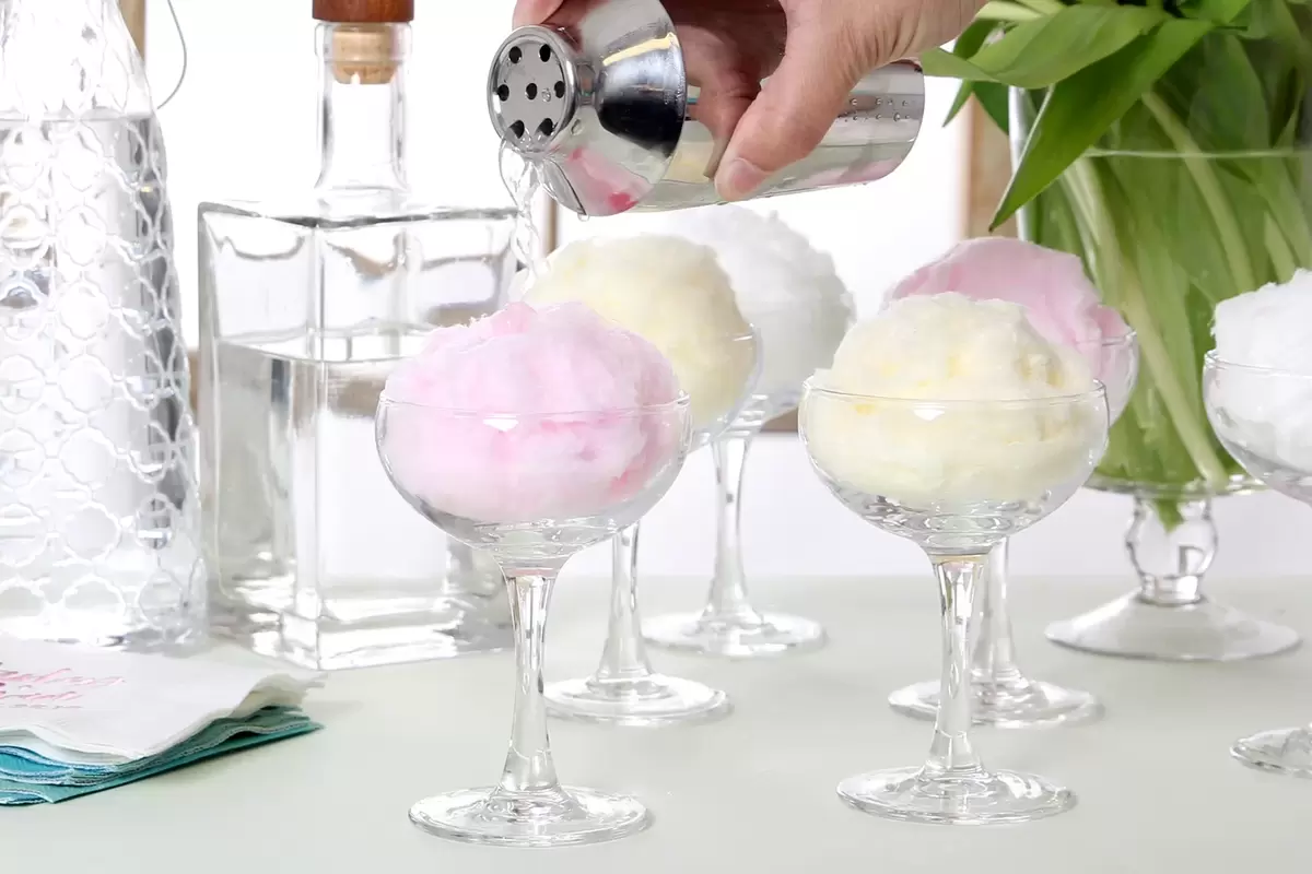 cotton candy dissolving into cosmopolitan drinks