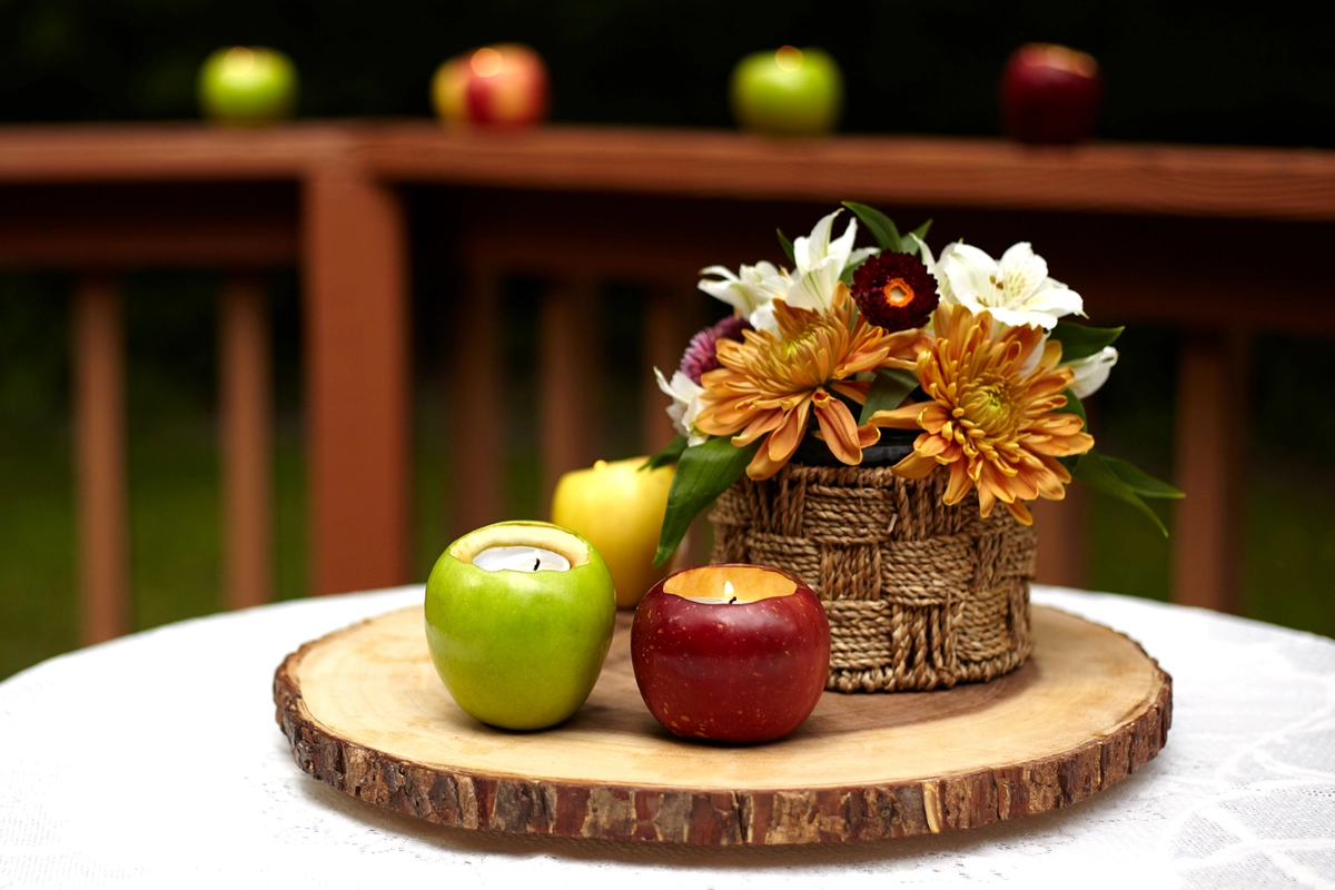 fall centerpiece with apples, flowers and diy votive candle holders