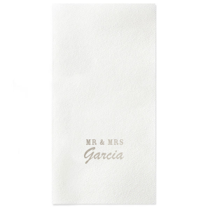 Introduce newlywed style with the Mr & Mrs Block Napkin. Bold block letters joyously announce the union, while the elegantly scripted surname dances below, adding a touch of grace. Perfect for a celebration that unites style and sentiment in every single fold.