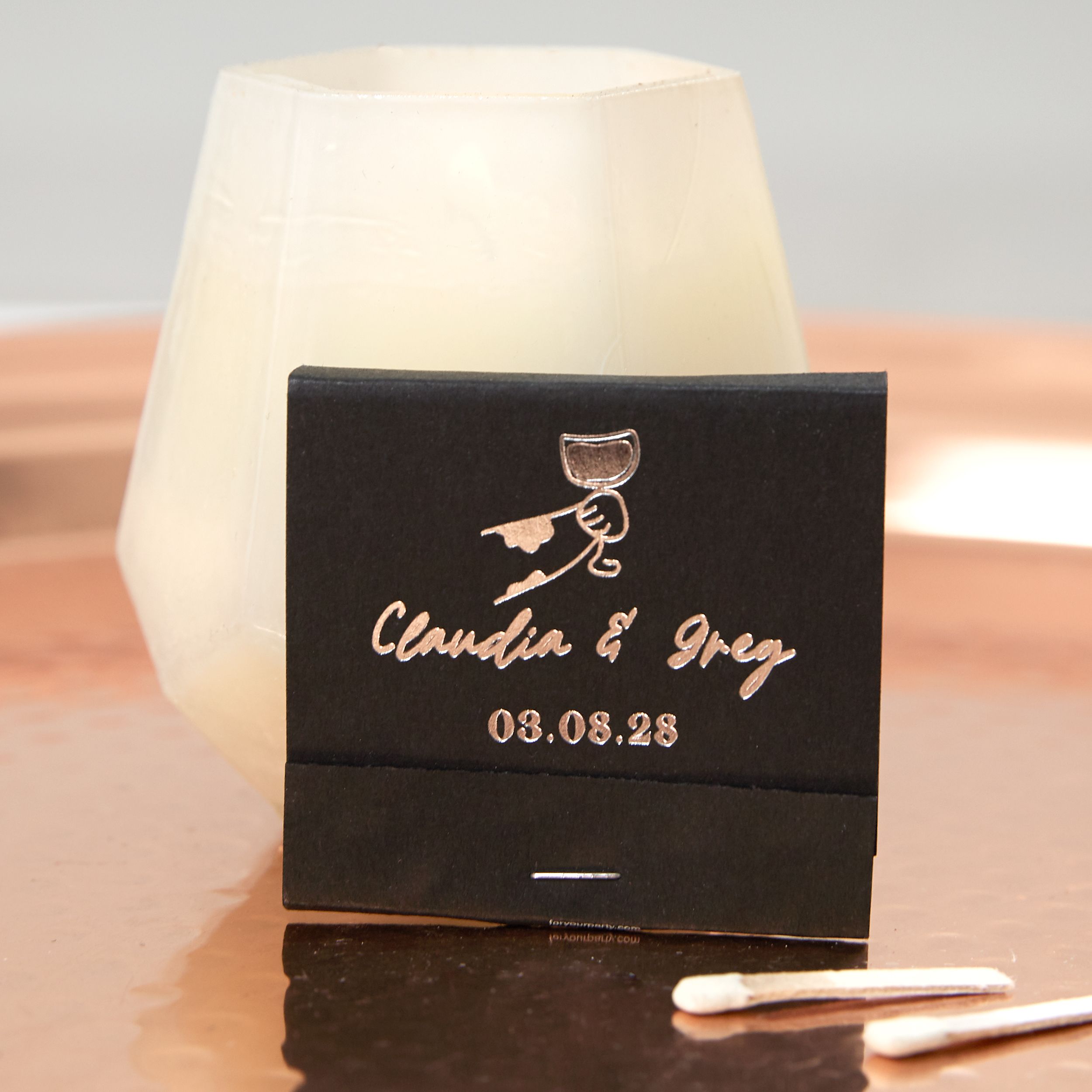 black matchbook printed with cat paw holding a wine glass