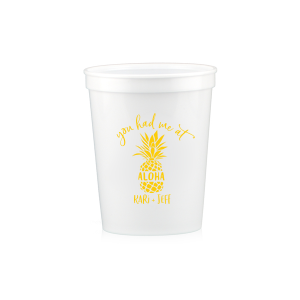 Sip the Tropical Romance. Raise a toast with the You had Me at Aloha Cup. Featuring a charming pineapple graphic with "Aloha" banded across it, this design gives a playful twist to a classic romantic movie line. Perfect for couples who want to add a touch of Hawaiian charm to their special day.

