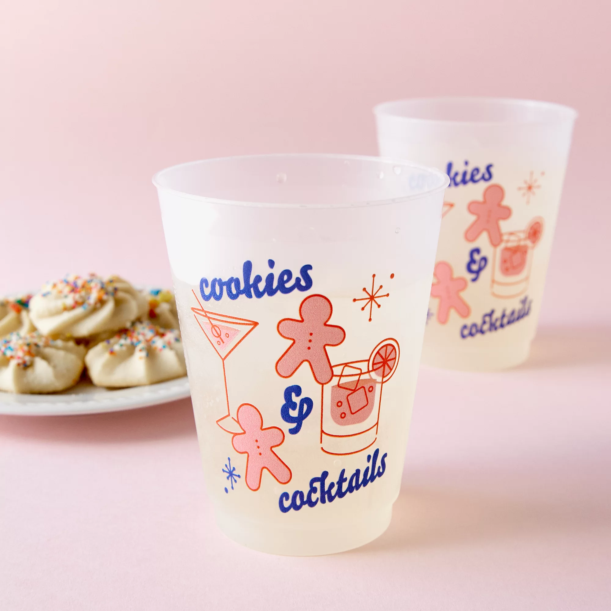 Cookies and cocktails cup with martini and gingerbread graphic styled with a plate of cookies