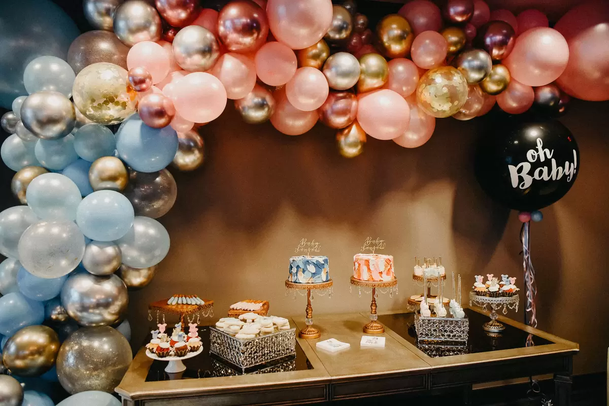 elegant shimmer gender reveal party sweets table
