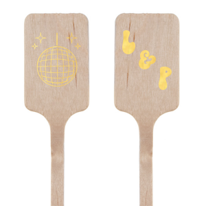 Our Groovy Initials Stir Stick captures the excitement and energy of a night out with a sparkling disco ball graphic on one side, setting the tone for a fun-filled event. On the other side, your initials are showcased in a font that has a retro nod. This personalized stir stick is the perfect addition to any celebration looking to combine romance with the vibrant pulse of the dance floor.