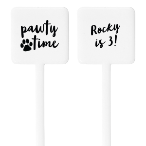The Pawty Time Stir Stick celebrates milestones with a customized declaration perfect for adding a personal touch to your, your child's, or your pet's special day. The reverse side features an adorable paw print graphic with the playful words "Pawty Time," also in the same relaxed script, setting the tone for a fun-filled event. This charming stirrer is a delightful accessory for birthday parties, pet adoption anniversaries, or any occasion worth throwing a "pawty" for.