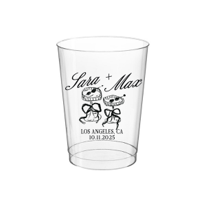 The Wedding Glass & Bow Cup is the must have trendy design for your one of a kind lifetime event. Featuring hand-drawn bows tied around champagne glasses alongside customizable text in the screen printed ink color of your choice to best pair with your party's vibe.