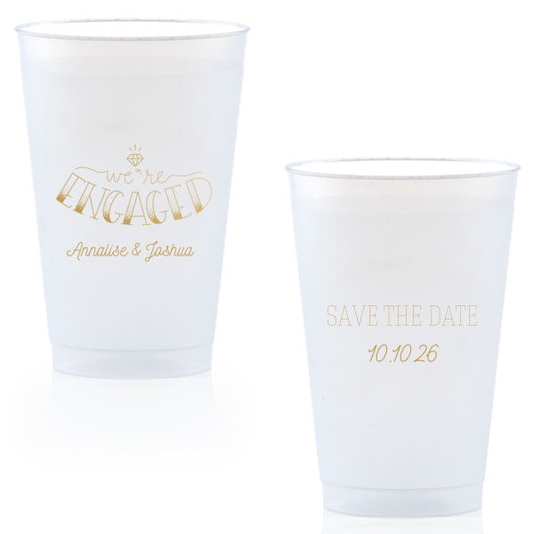 The Diamond Engagement Cup design dazzles with a sparkling diamond graphic and bold "ENGAGED" in 3D artistry. Scripted "we’re" and the couple's names add charm, while the other side cheerfully announces "Save the Date," infusing the cup with celebratory excitement and anticipation.