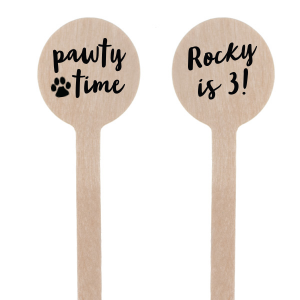 The Pawty Time Stir Stick celebrates milestones with a customized declaration perfect for adding a personal touch to your, your child's, or your pet's special day. The reverse side features an adorable paw print graphic with the playful words "Pawty Time," also in the same relaxed script, setting the tone for a fun-filled event. This charming stirrer is a delightful accessory for birthday parties, pet adoption anniversaries, or any occasion worth throwing a "pawty" for.