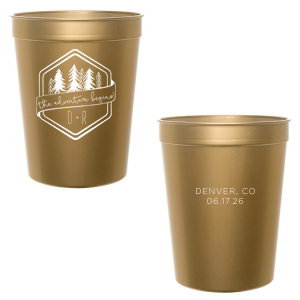 Set off on a new journey with the Adventure Begins Cup, a two-sided celebration of nature and new beginnings. One side, framed by a hexagonal border, showcases ‘the adventure begins’ on a banner, flanked by diverse evergreen trees and the couple’s initials. The other side commemorates the event with the location and date, perfectly encapsulating the spirit of adventure and personal milestones."