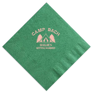 Gather around the campfire with the Camp Bachelorette Wilderness Napkin, personalized with "Camp Bach" arching over a charming tent and trees graphic, and the bachelorette's name prominently displayed below. A rustic yet chic touch to any outdoor bachelorette adventure.