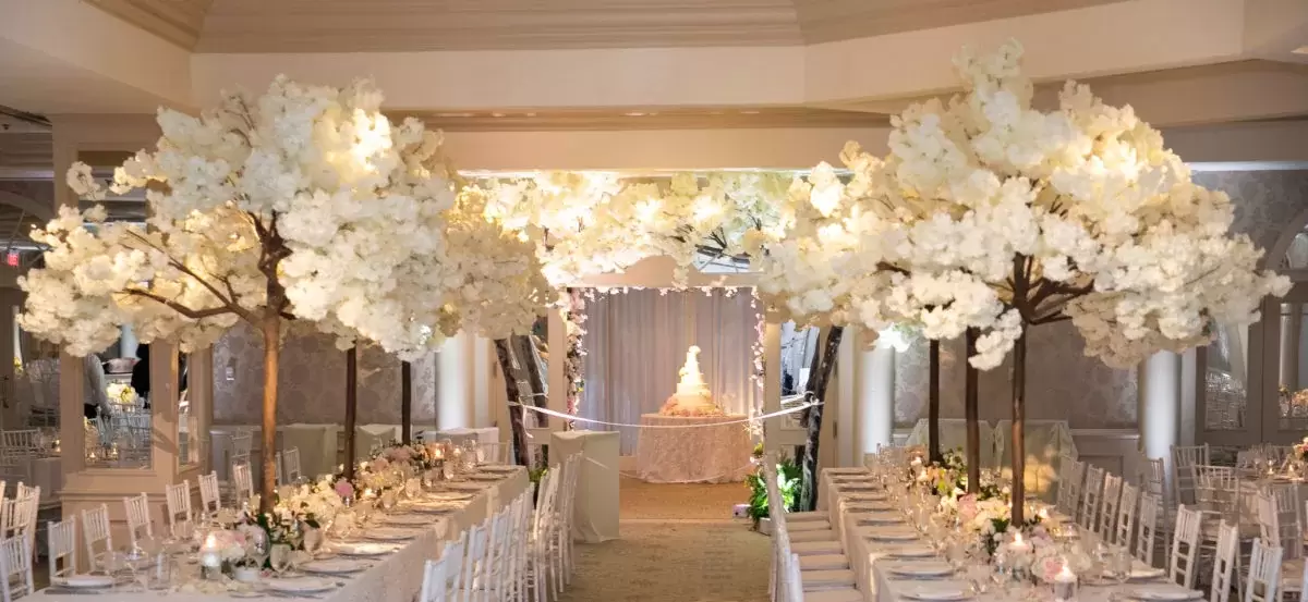 stunning white trees on wedding reception tables