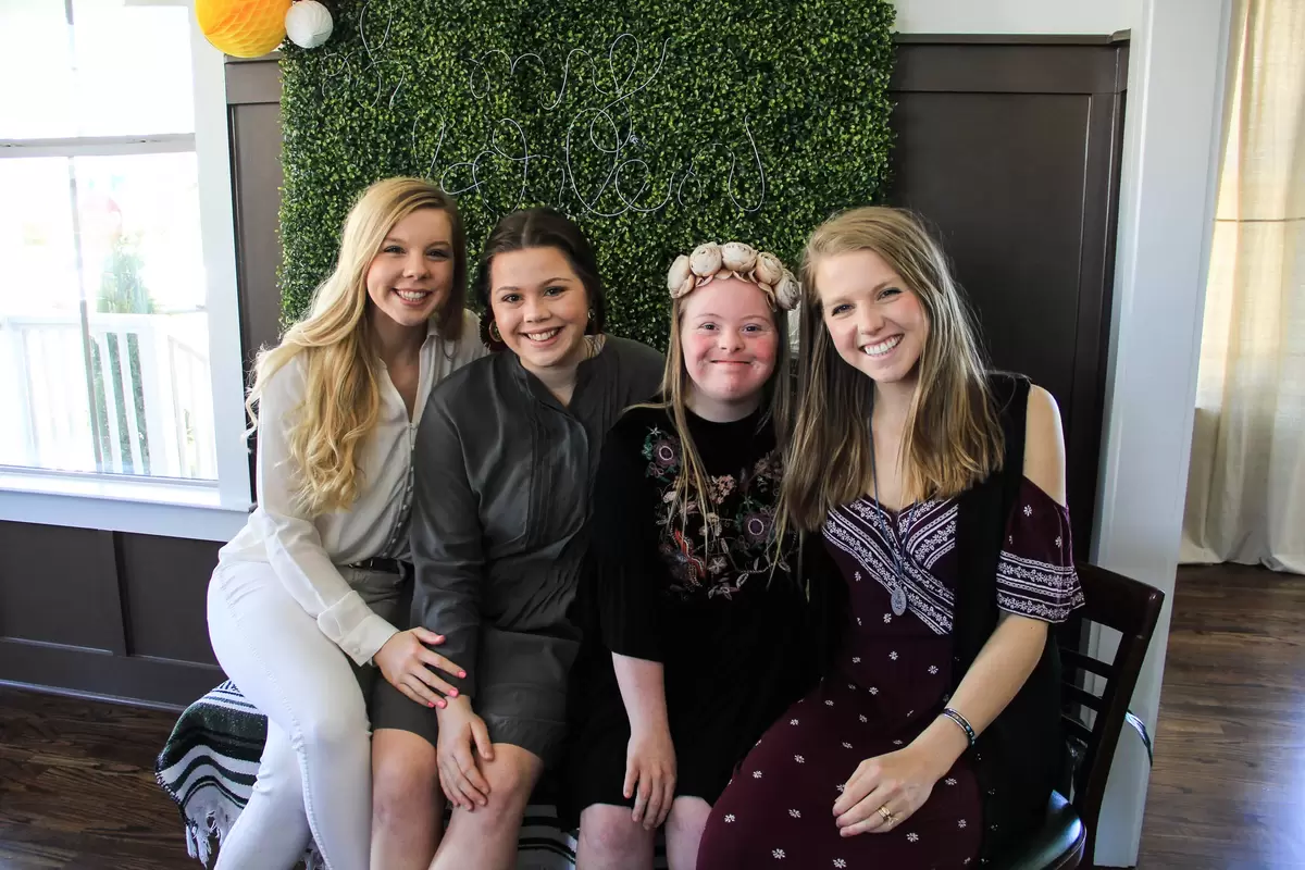 bride with her sisters at bridal shower photo booth
