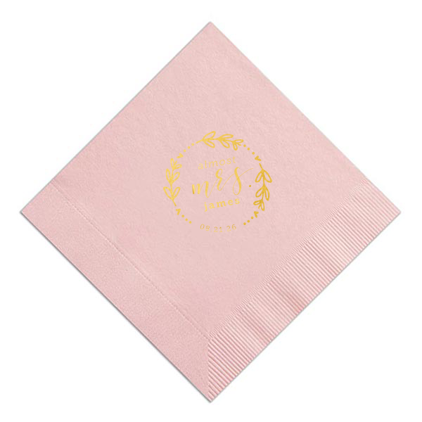 The Almost Mrs Heart Frame Bridal Shower Napkin joyfully heralds the bride-to-be's journey from Miss to Mrs. Encircled by a heart-leaf frame, the flowing, swirling script of "Mrs." takes center stage, accompanied by her soon-to-be last name and the wedding date. A charming, celebratory design!