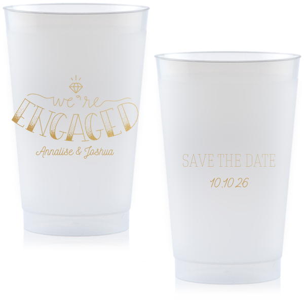 The Diamond Engagement Cup design dazzles with a sparkling diamond graphic and bold "ENGAGED" in 3D artistry. Scripted "we’re" and the couple's names add charm, while the other side cheerfully announces "Save the Date," infusing the cup with celebratory excitement and anticipation.