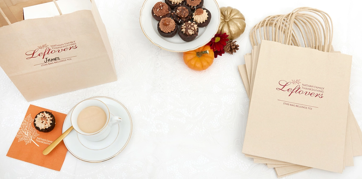 Mini desserts on a platter with custom bags that say "Nathan Family Thanksgiving Leftovers" 