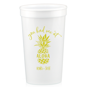 Sip the Tropical Romance. Raise a toast with the You had Me at Aloha Cup. Featuring a charming pineapple graphic with "Aloha" banded across it, this design gives a playful twist to a classic romantic movie line. Perfect for couples who want to add a touch of Hawaiian charm to their special day.

