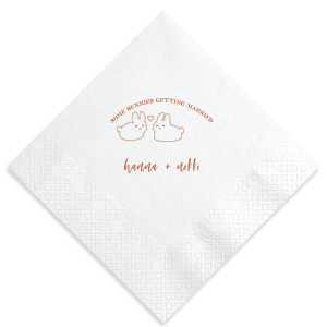Hop into matrimonial joy with the Some Bunnies Wedding Napkin, complete with an adorable drawing of two bunnies and a heart nestled between them. The playful phrase "Some Bunnies Getting Married" sets a whimsical tone, while the area below awaits the couple's names, scripted with modern elegance. A delightful addition to your wedding tablescapes.