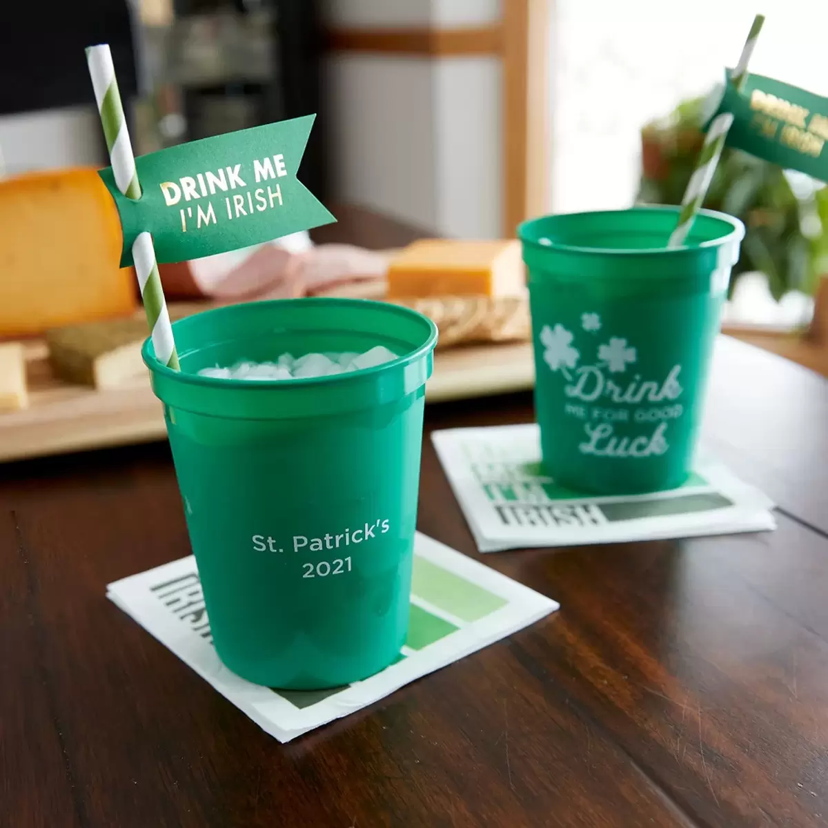 two green cups with green patterned straws
