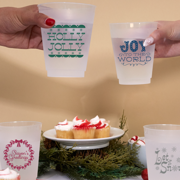 Hands holding up party cups for Christmas
