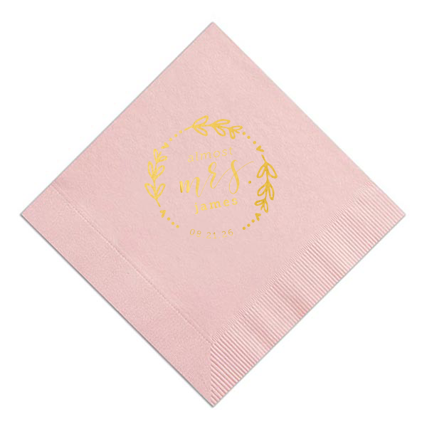 The Almost Mrs Heart Frame Bridal Shower Napkin joyfully heralds the bride-to-be's journey from Miss to Mrs. Encircled by a heart-leaf frame, the flowing, swirling script of "Mrs." takes center stage, accompanied by her soon-to-be last name and the wedding date. A charming, celebratory design!