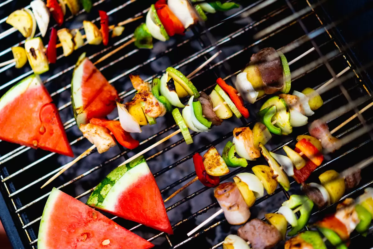 grilled kebobs and watermelon at summer BBQ graduation party