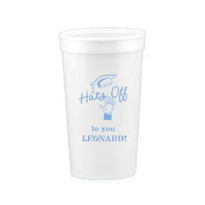 Celebrate the graduate's achievement with the Cap Toss Cheers Grad Cup, adorned with a hand throwing a graduation cap and the encouraging phrase "Hats off to you," alongside the name of the graduate. A personalized tribute to their hard work and bright future.