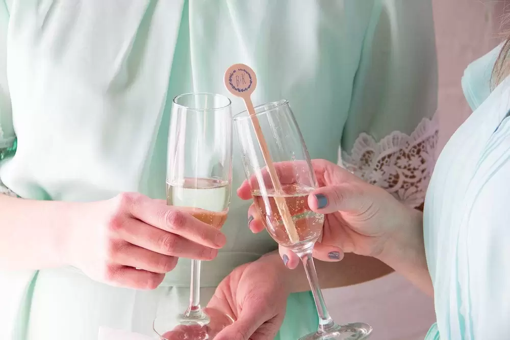 wedding champagne toast with custom cocktail stirrers