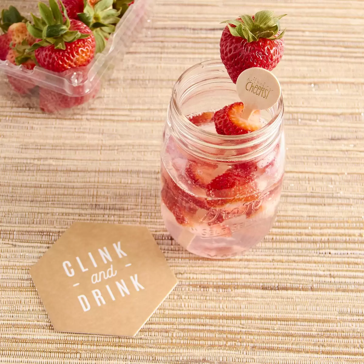 strawberry rose gin fizz with custom coasters and custom drink stirrers