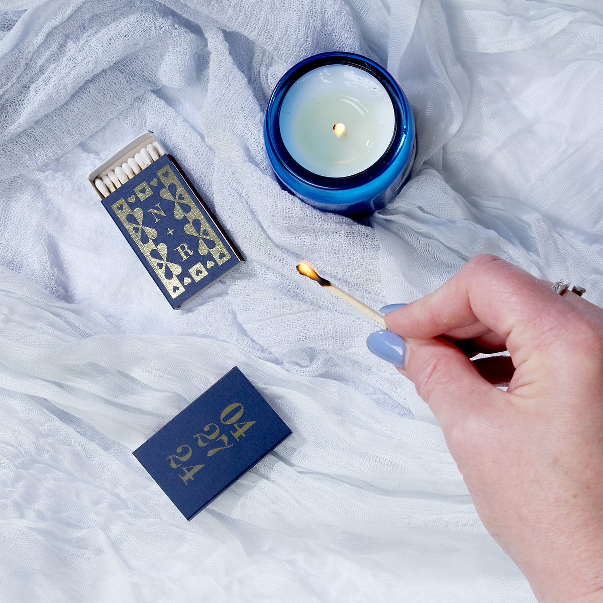 Navy blue custom matchboxes with lit match