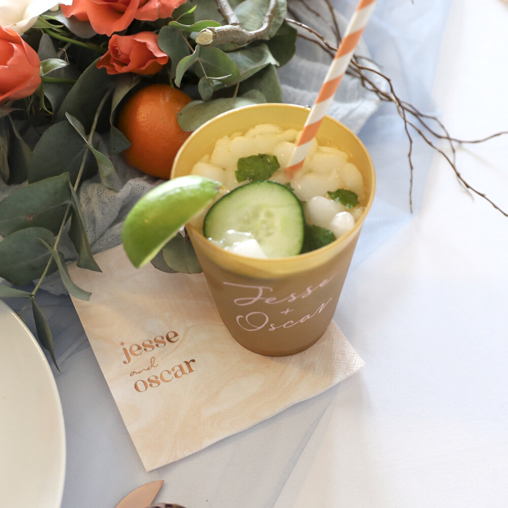 Finished Mojito in a cup, with lime and cucumber garnish