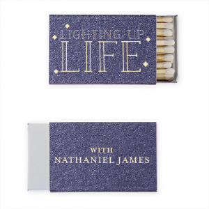 Illuminate any occasion with the Lighting Up Life Matchbox, where 'LIFE' shines bright among festive twinkles. Flip to reveal 'with' alongside the celebrant's name, capturing the radiant impact they have on every guest's life.