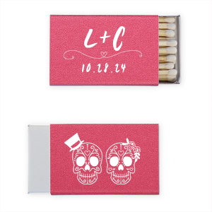 Celebrate eternal love with the Skull Couple Wedding Matchbox. Adorned with delightful sugar skulls, these matchboxes honor Dia de los Muertos—celebrating life and love. The back features the newlywed's initials and the event date, making it a unique token of vibrant tradition and joy.