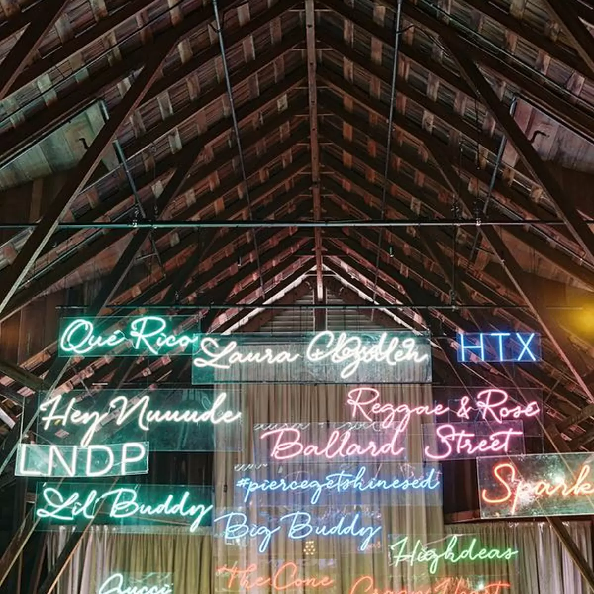 neon wedding signs hanging from the ceiling