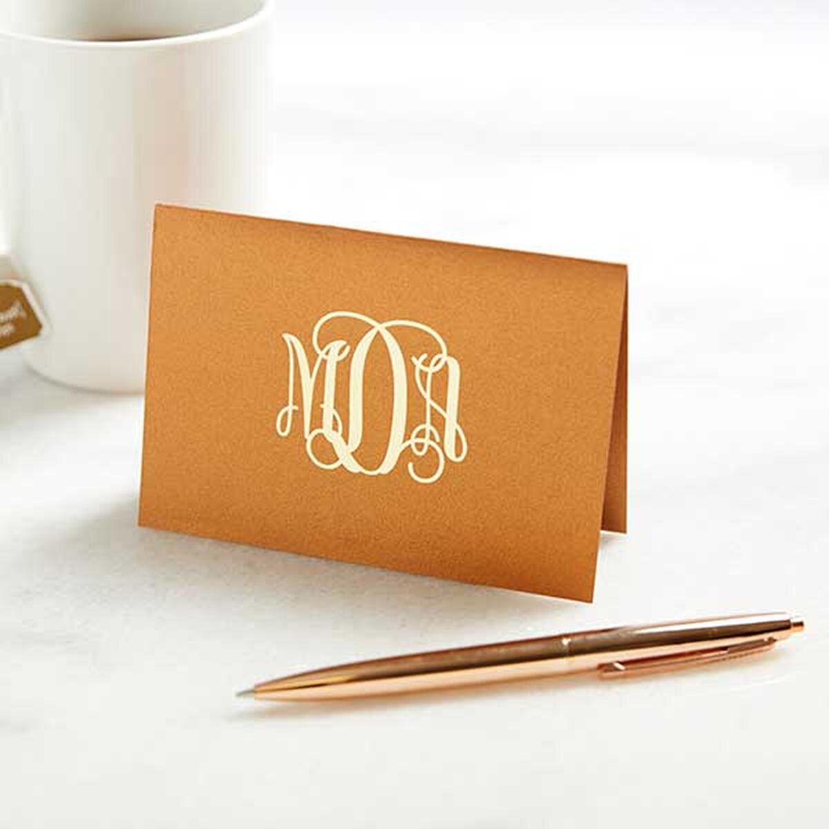 Gold A2 note card with white foil stamped monogram on front