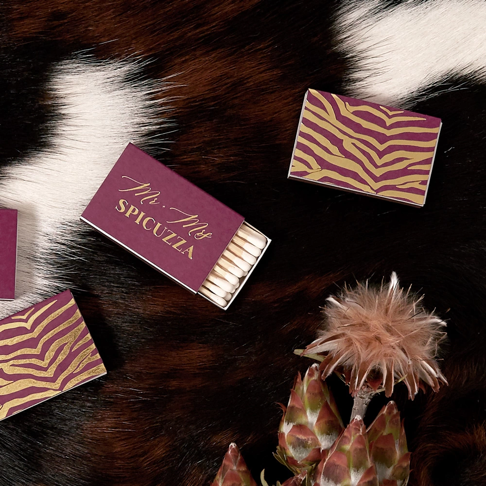 Vibrant plum wedding matchboxes with glittering gold foil stamping are a fabulous wedding favor.