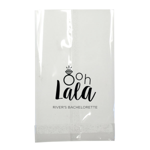 Delight guests with the Ooh Lala Bachelorette Bag, where a glimmering solitaire ring cleverly becomes the 'O' in 'Ooh.' 'Lala' whimsically precedes the bride-to-be's name, making this bag a charming memento of celebration and friendship.