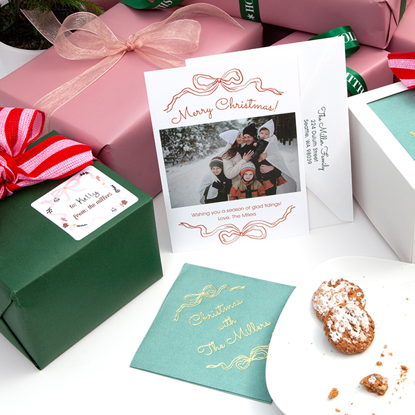 Printed holiday photo card on a pink background