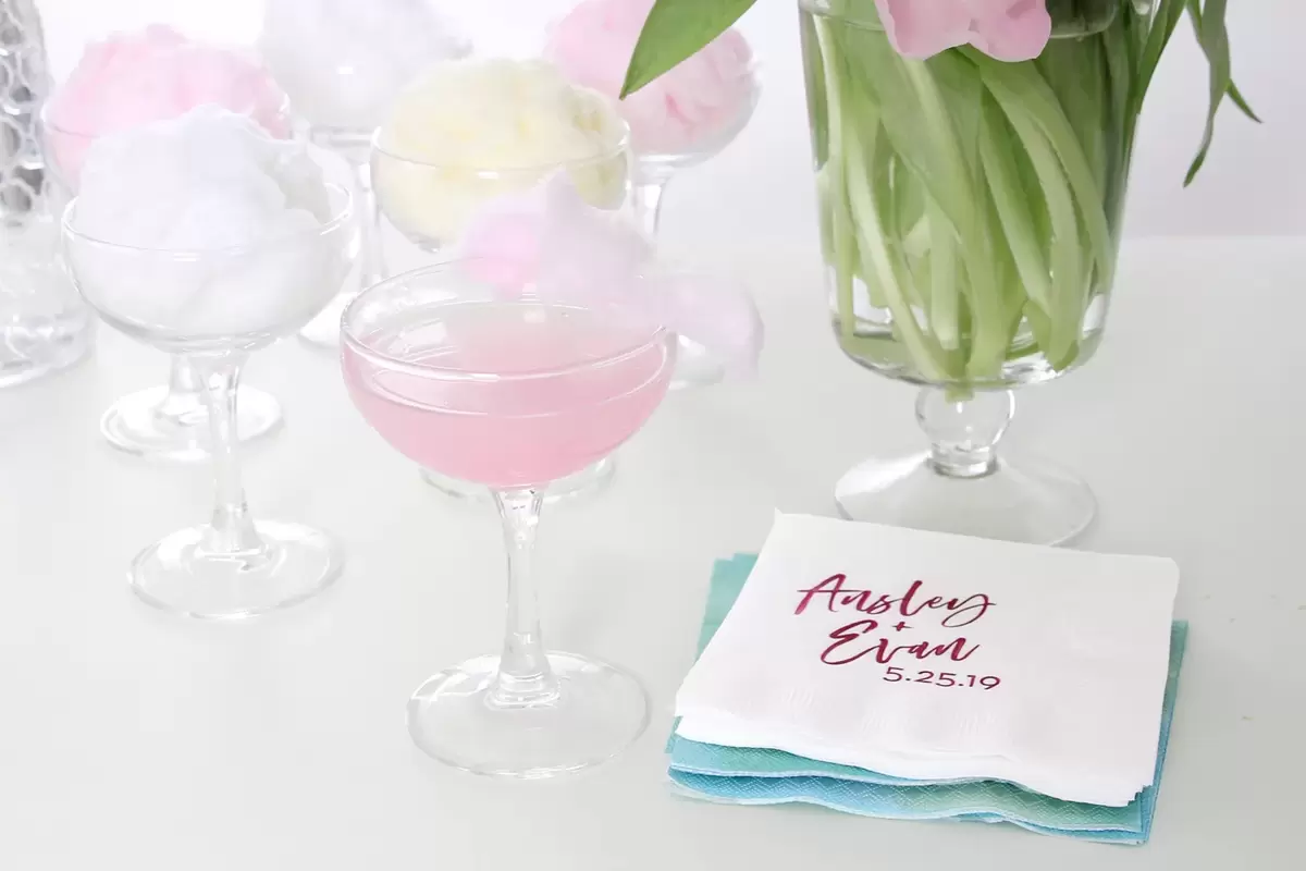 cotton candy cosmopolitan with personalized cocktail napkins