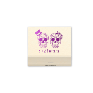 Celebrate love and life with the Sugar Skull Couple Match. Featuring vibrantly detailed skulls adorned with a top hat and floral headband, this artistic design nods to the joyous spirit of Día de los Muertos. Displaying the couple's initials and event date, it's a colorful keepsake full of cultural charm and festivity.